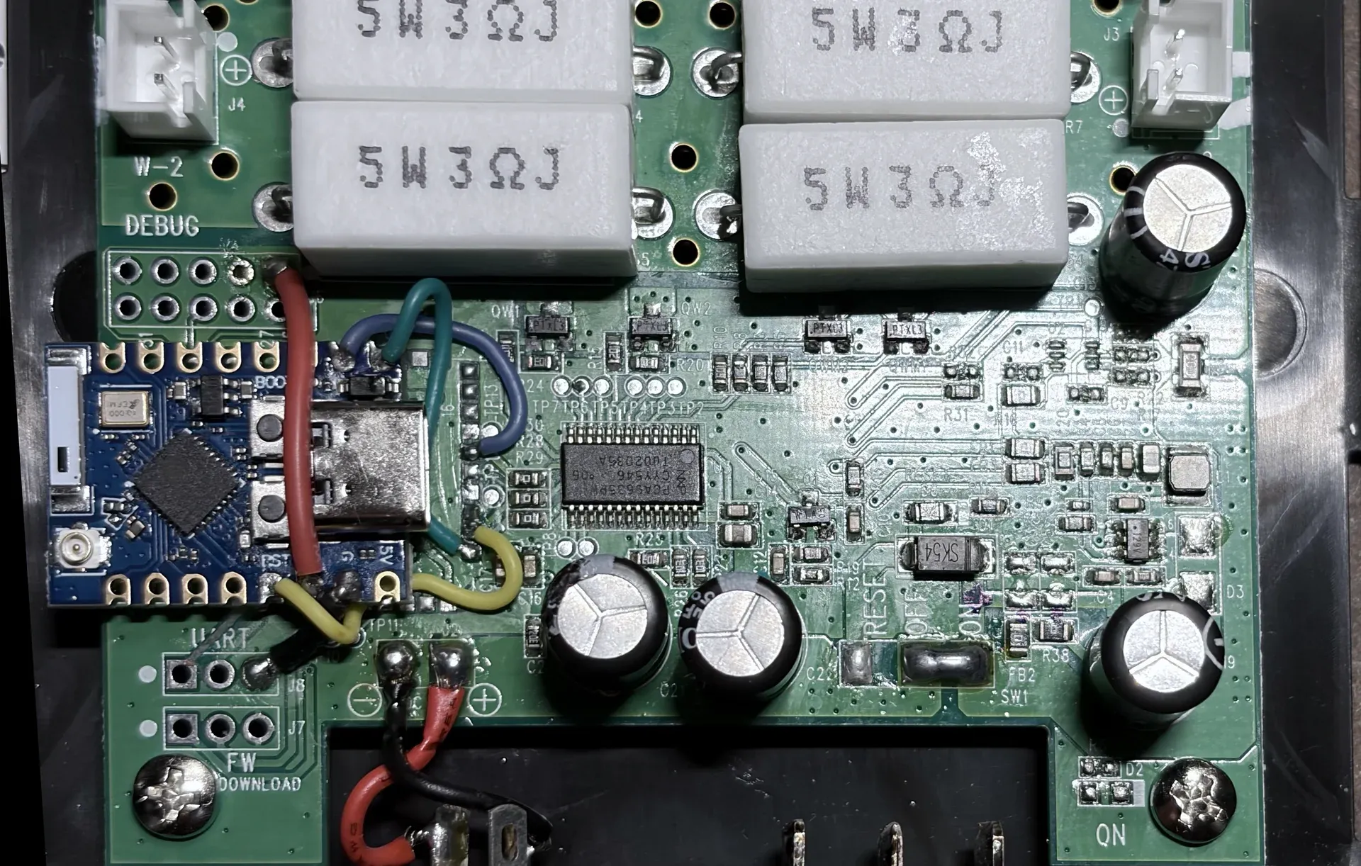 The blue ESP32-C3 fitted beside the retained PCA9635 and stock LED circuitry, with the five-wire harness attached.